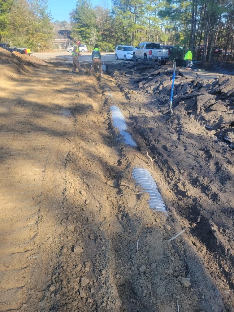 Storm drain pipe installation with backhoe